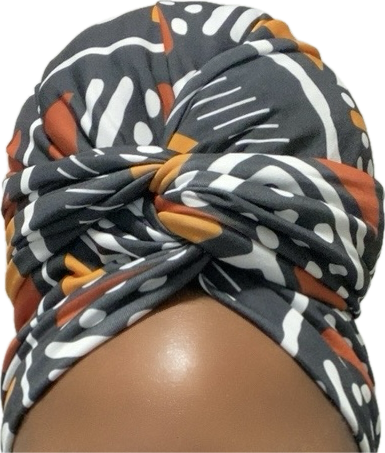 Colorful patterned headscarf on a mannequin head with a white background